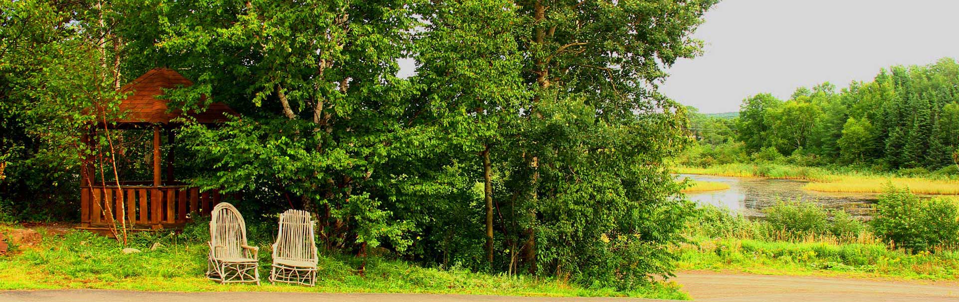 A peaceful pond and wooded countryside at Brookdale Country Inn